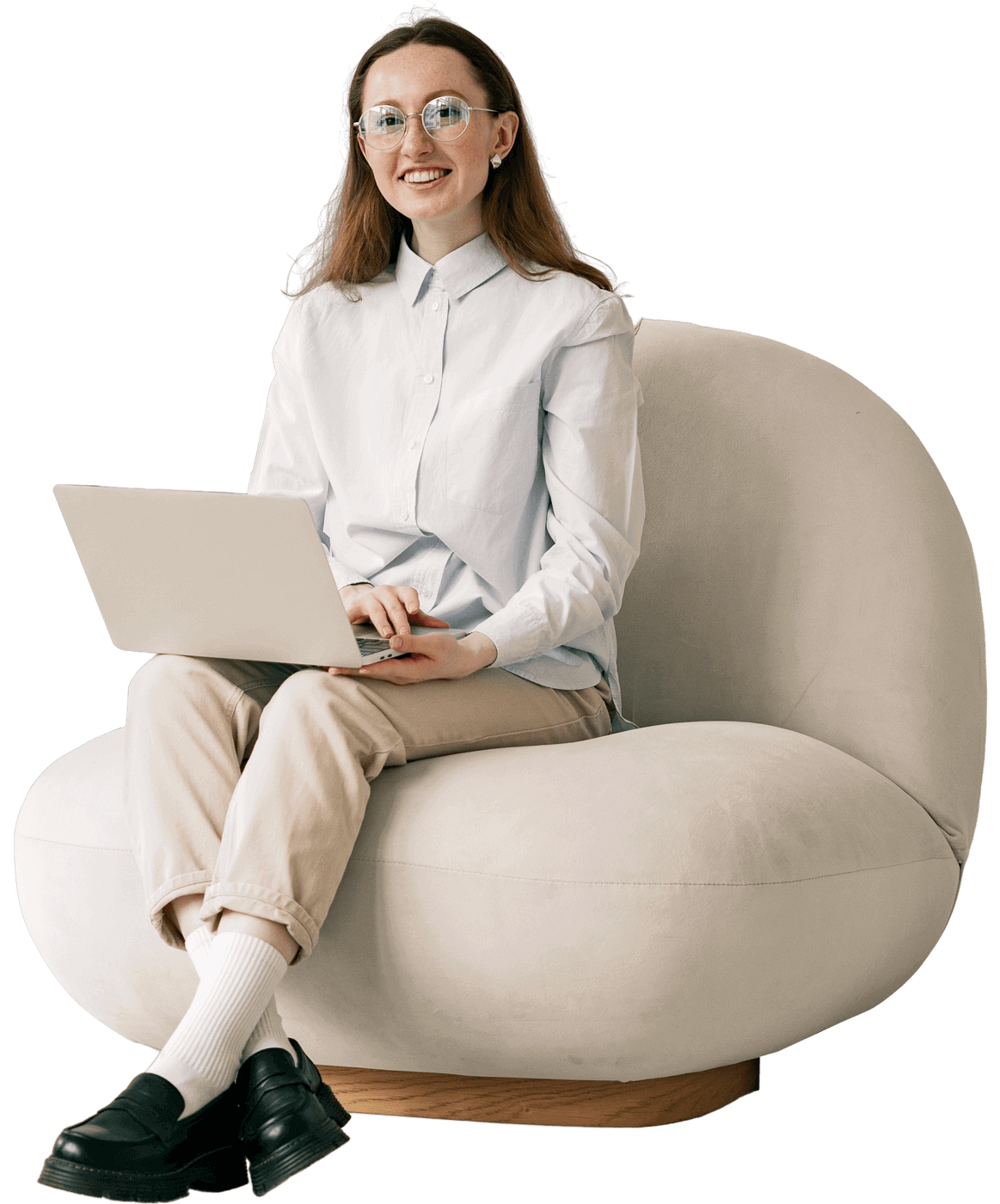 female college sitting in chair with open laptop